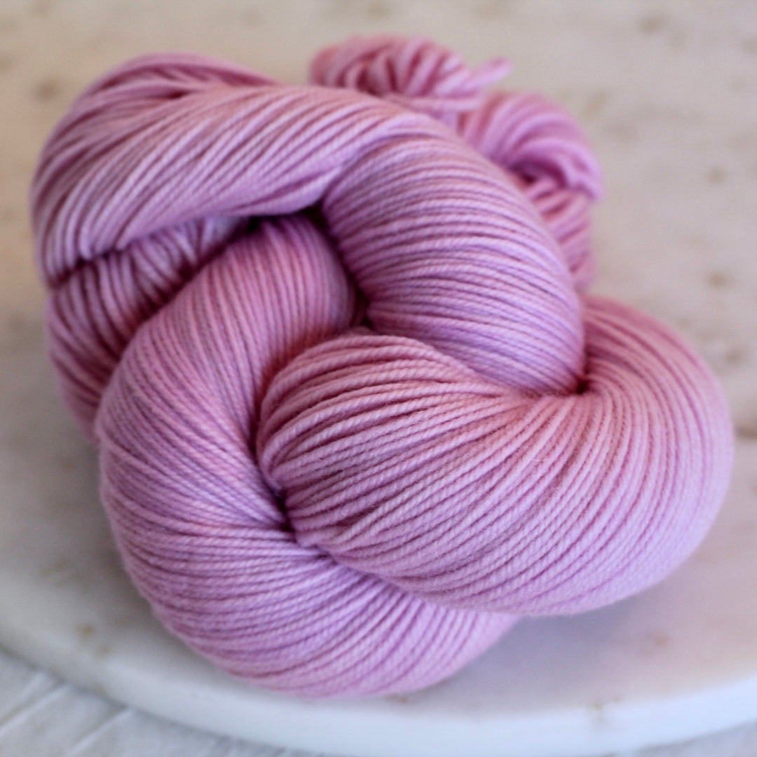 Pink skein of yarn on a light background