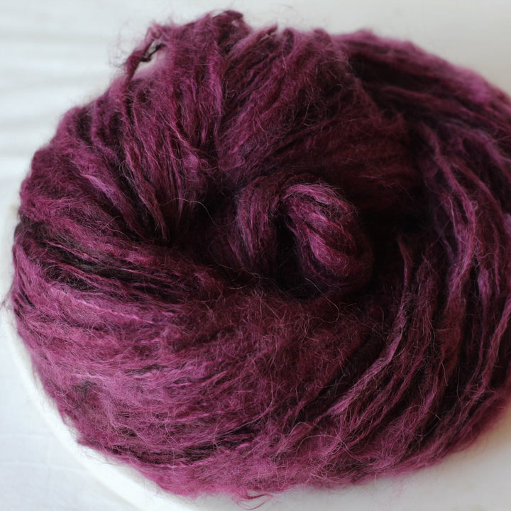 Burgundy yarn on a marble plate