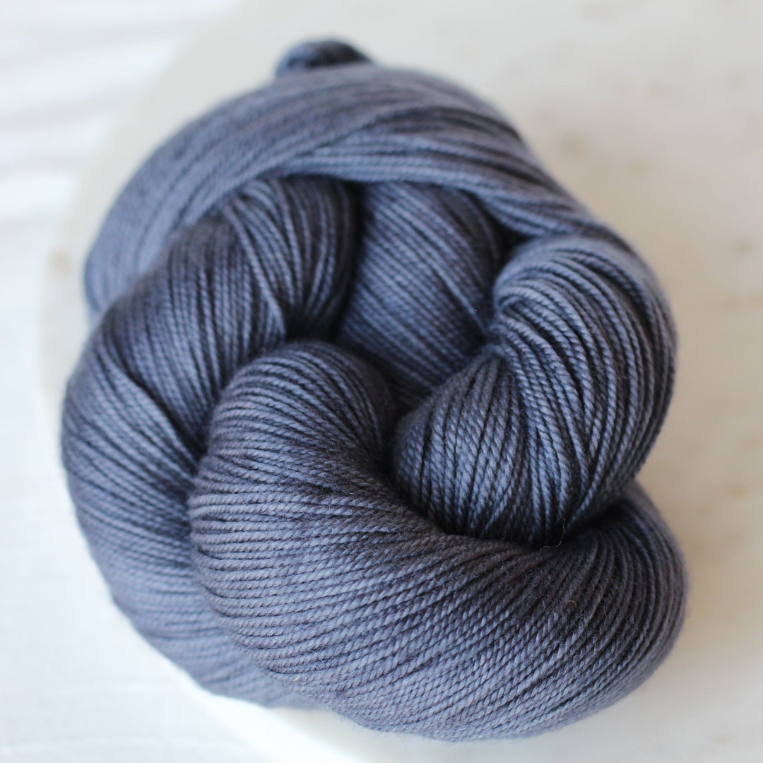 Navy Blue with gray skein of yarn on marble