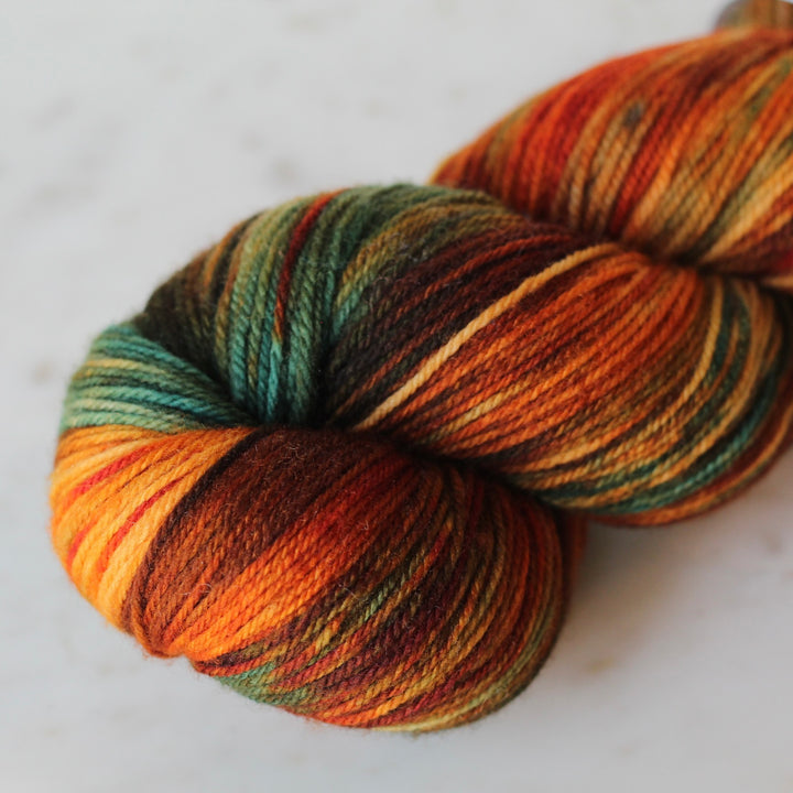 Multicolored Fall Colors skein of yarn on a light background