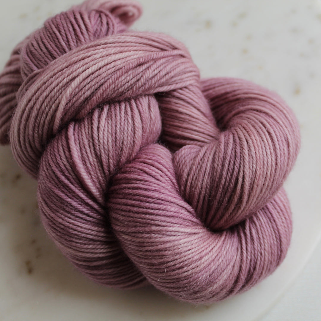 Pink mauve yarn on marble plate