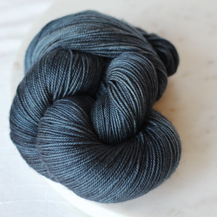 Deep Teal Blue yarn on a marble plate
