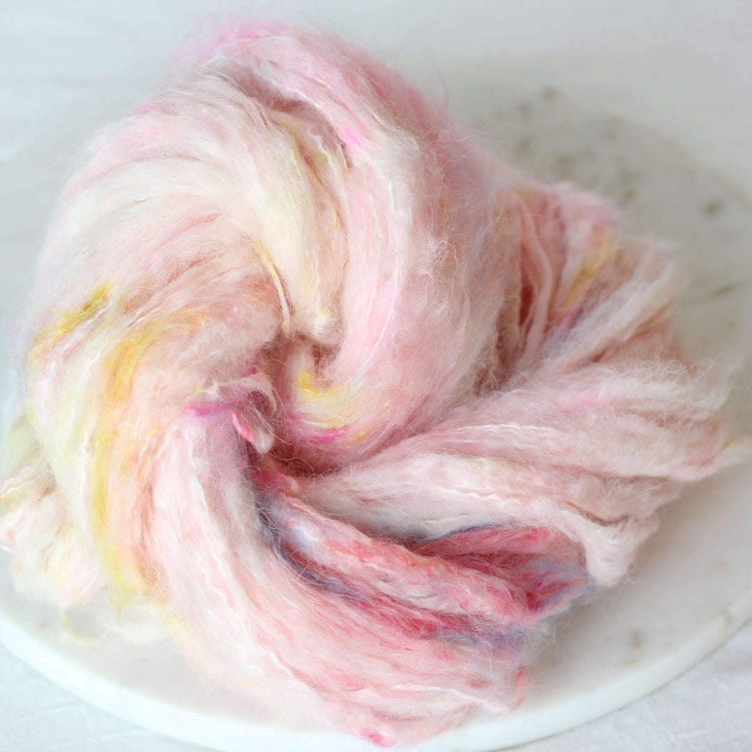 Colorful yarn ball on a white plate