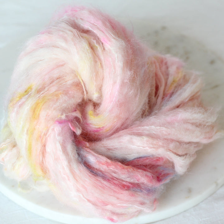 Colorful yarn ball on a white plate