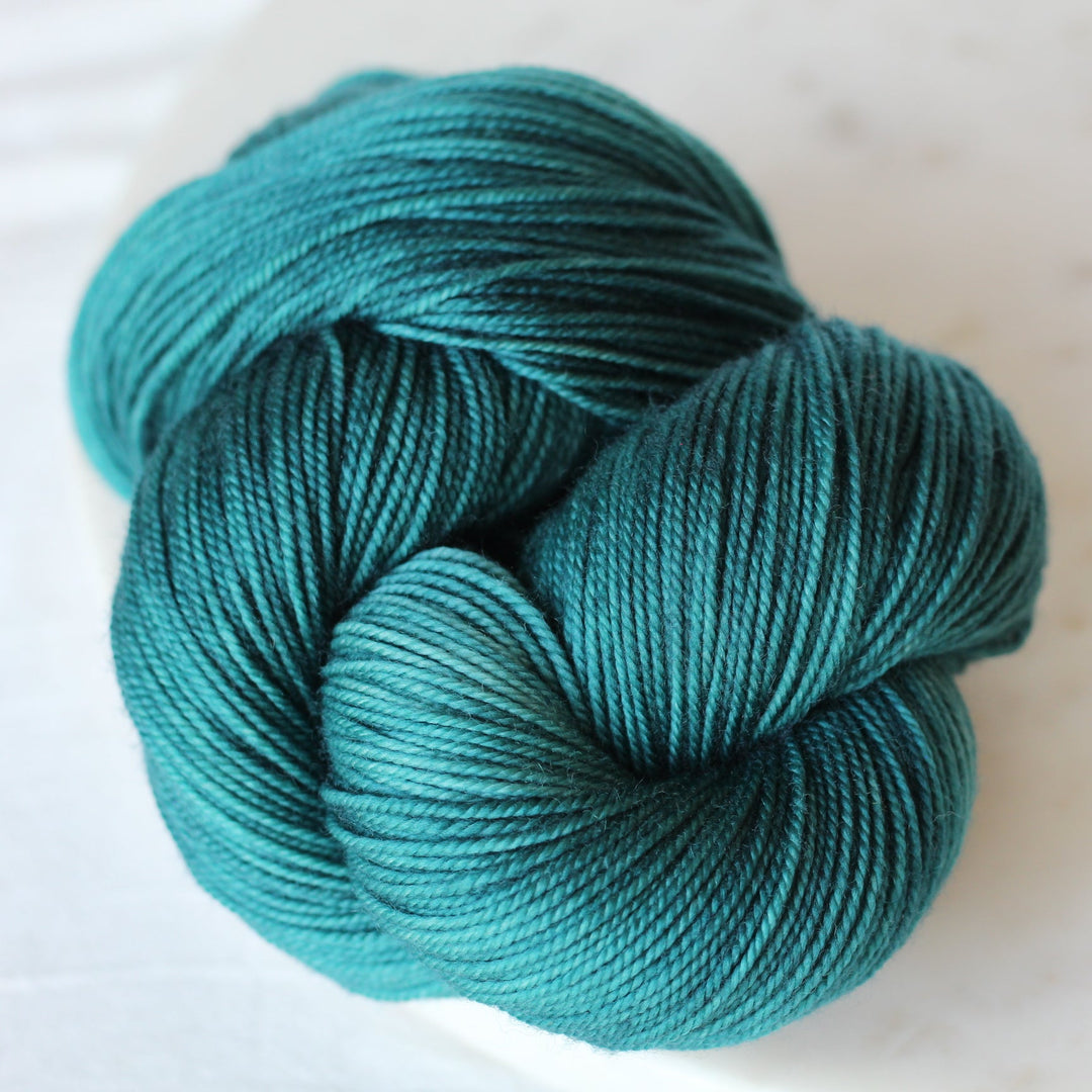 Turquoise skein of yarn on a light background