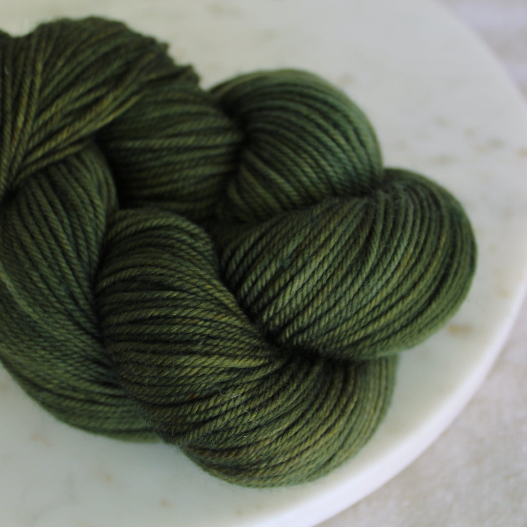 deep green yarn on marble plate